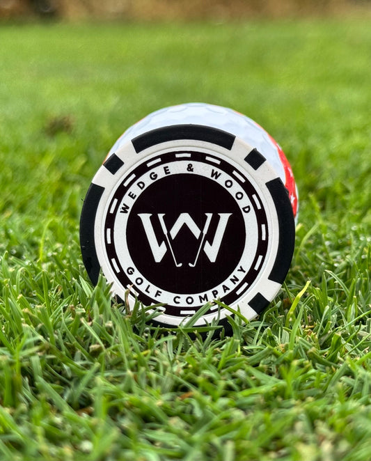 Wedge and Wood poker chip ball marker on golfing green