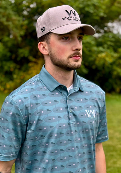 Man wearing Greens logo golf polo shirt with golf course in background