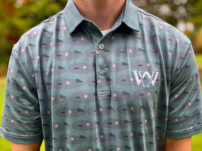Close up of material and pattern of Wedge and Wood Greens logo polo shirt
