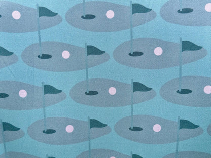 Close up of sublimated print of golf green on Wedge and Wood Greens polo shirt