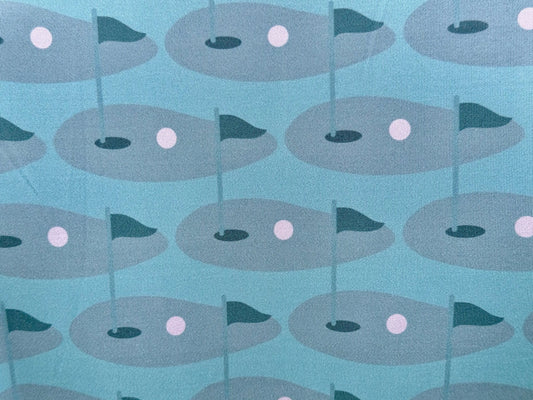 Close up of sublimated print of golf green on Wedge and Wood Greens polo shirt