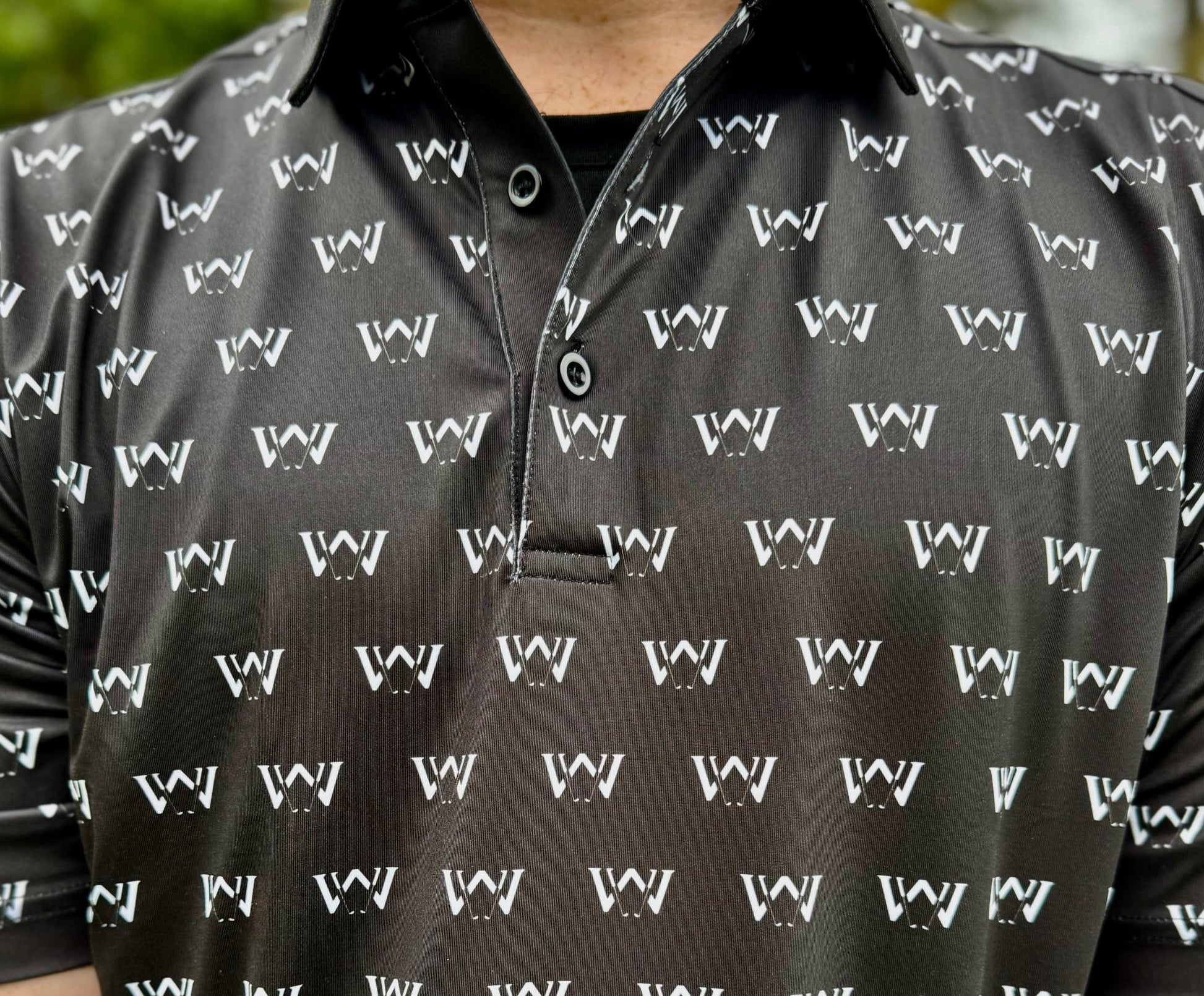 Close up of print and material of Wedge and Wood black OG logo polo shirt