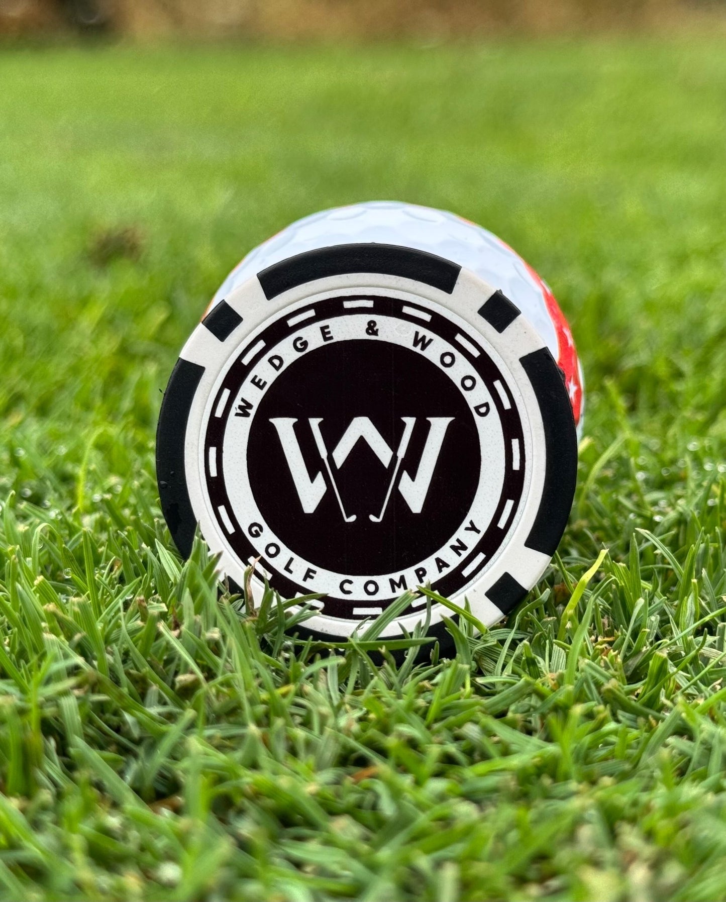 Wedge and Wood poker chip ball marker on golfing green
